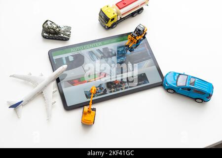 Tablet computer with different types of toy transport. auto center Stock Photo