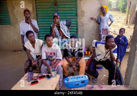 Burkina Faso, Ouagadougou; Group of shoeshine boys waiting for a client Stock Photo