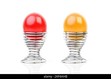 Ein rotes und ein gelbes Ei im Eierbecher, Osterei, Ostereier, Ostern, Brauchtum, Stock Photo
