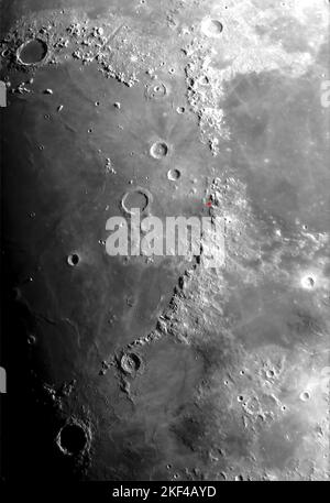Moon surface and large craters around the Apenines, Mare Serenitatis and Mare Imbrium.  Apollo 15 landing site is marked in red. Stock Photo