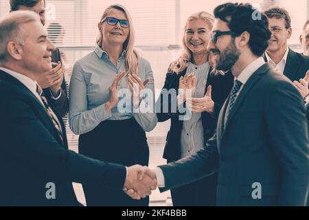 happy business partners shaking hands. the concept of cooperati Stock Photo