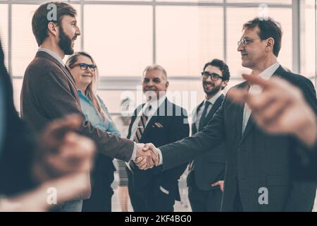 confident business people shaking hands with each other. Stock Photo