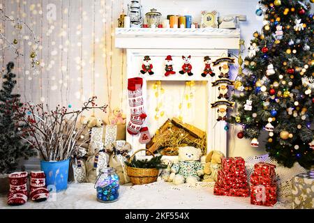 Christmas and New Year interior with blurry lights with Christmas tree and fireplace Stock Photo
