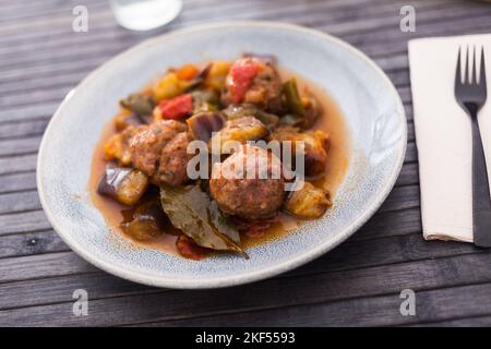 cooked meatballs with stewed eggplant in bowl Stock Photo
