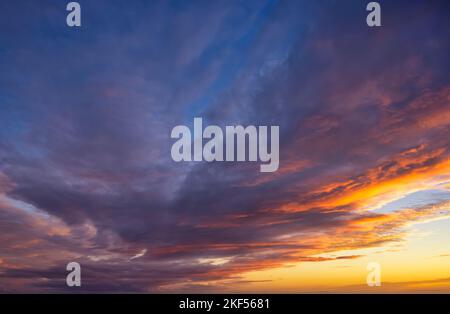 A vibrant sunset sky with orange, magenta and blue colors Stock Photo
