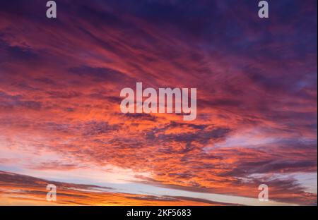 A sunrise sky with cloudscape in soft magenta, pink and orange tones Stock Photo
