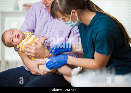 An nurse giving a baby an injection Stock Photo - Alamy