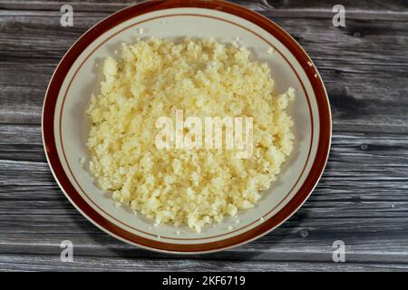 Arabian Cuisine dish of small steamed granules of rolled durum wheat semolina called Koskosi, couscous, kusksi or kseksu, popular in Morocco, Algeria, Stock Photo