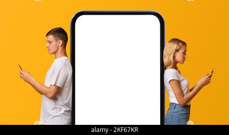 New App. Young Couple Leaning At Big Blank Smartphone With White Screen Stock Photo