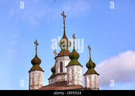 Eastern orthodox crosses on gold domes, cupolas, against blue sky with clouds Stock Photo