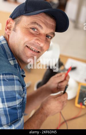 electrician engineer tests electrical installations Stock Photo