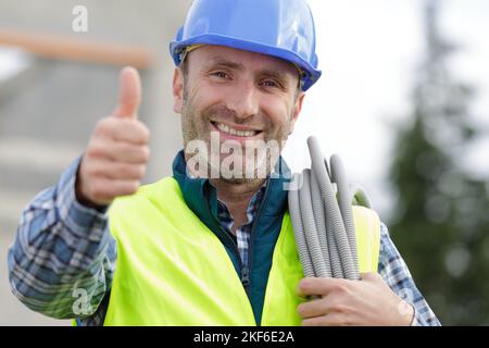 worker with personal protective equipment shows thumb up Stock Photo