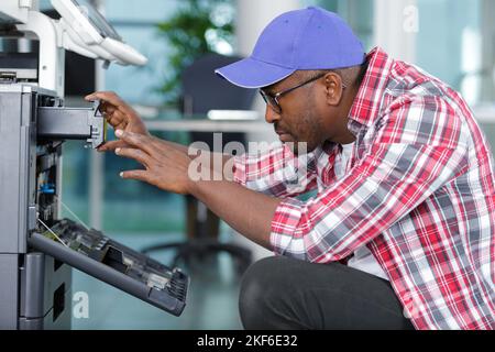 a technician is checking a printer Stock Photo