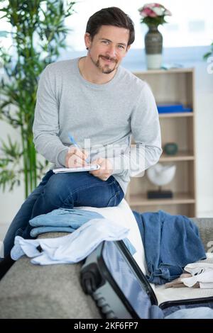 man packing the luggage prepare for their journey trip Stock Photo