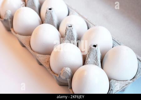 Close-up of ten white eggs in a paper tray. Eggs contain vitamins, phosphorus, zinc and a lot of choline. Egg container for recyclable materials Stock Photo