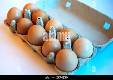 Close-up of ten brown eggs in a paper tray. Eggs contain vitamins, phosphorus, zinc and a lot of choline. Egg container for recyclable materials Stock Photo