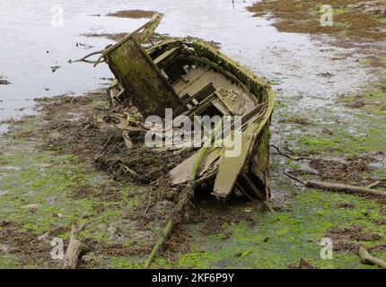 Small wooden boat abandoned and rotting in the estuary of the River Ason Colindres Cantabria Spain Stock Photo