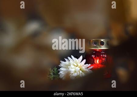 Memorial candle and white chrysanthemum. Sympathy card background with copy space Stock Photo