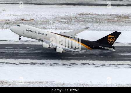 UPS Cargo Boeing 747-400F aircraft taking off from Anchorage Airport after a heavy snow fall. Airplane of UPS Cargo 747 freighter departure with snow. Stock Photo