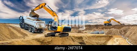 excavator is digging and loading at construction site Stock Photo