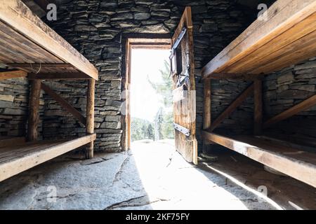 Wood bunks inside historic stone cabin near the summit of San Jacinto Peak in San Jacinto Mountains State Park above Palm Springs, California. Stock Photo