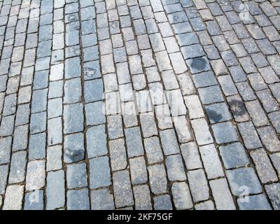 Old paving stones made of natural stone on Red Square. Stock Photo