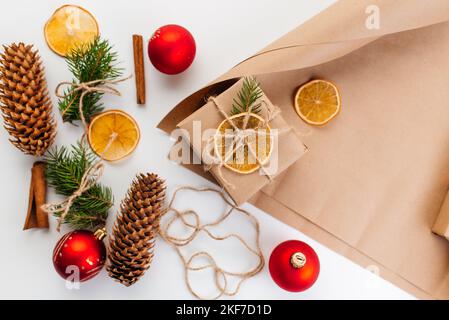 Christmas present wrapped in kraft paper with natural decoration Stock Photo