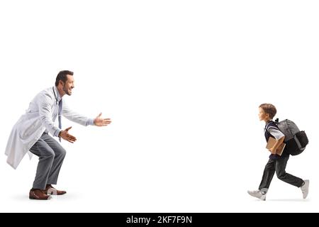 Schoolboy running towards a male doctor isolated on white background Stock Photo