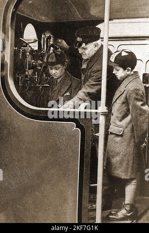 1930's image of two British schoolboys on the footplate of a steam engine.. Stock Photo