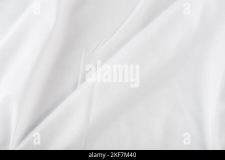 White fabric abstract background concept. white wrinkled silk cloth wave  texture satin material Stock Photo