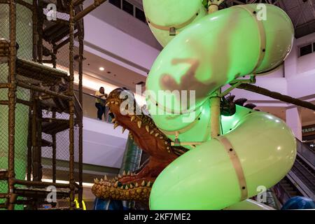 Children enjoy playground tubular slide in shopping mall while parents go shopping. Rio de Janeiro, Brazil. Stock Photo