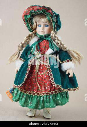 Vintage porcelain doll girl blonde with braids with blue eyes in a