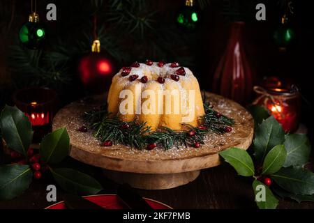 Bundt cake decorated with sugar icing and Pomegranate in Christmas mood. Moody atmosphere with candles and decoration. New Year's eve. Dessert called Stock Photo
