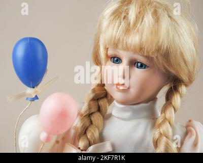 Vintage porcelain doll girl blonde with braids with blue eyes in a