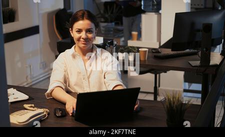 Portrait of successful confident woman doing research work on laptop, using online network. Empowered female entrepreneur working late at night, software developer creating web project. Stock Photo