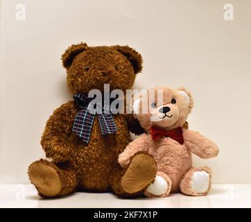 Brown an tan bears sitting side by side Stock Photo