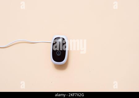 Wireless security camera isolated on beige color background. Stock Photo