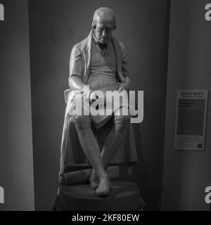 A grayscale of James Watt's statue in the museum of Glasgow University Stock Photo