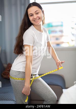 Measuring tape on girl's body Stock Photo by ©VelesStudio 117384564