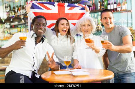 Diverse group celebrating with British flag Stock Photo