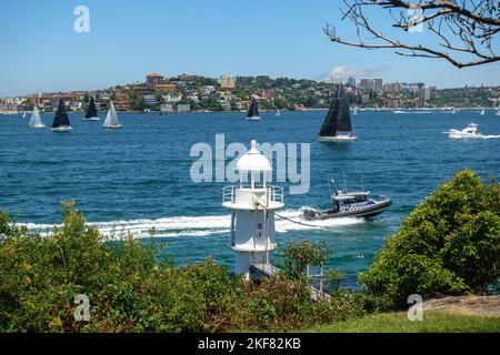 W water police boat passed by Bradleys Head Lighthouse in Sydney Harbour during the day Stock Photo