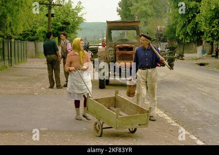 Prahova County, Romania, May 1990, a few months after the fall of communism. Local people on the main road of the village. Stock Photo