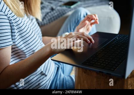 Working from home concept. Woman jands typing on laptop keyboard. Remote work from home workplace Stock Photo