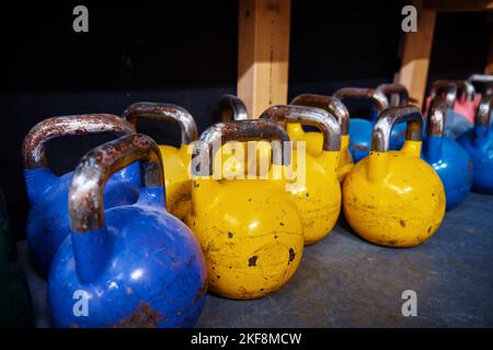 Row of colorful kettlebells in gym. Equipment for sport exercises. Sport activity and healthy lifestyle concept Stock Photo
