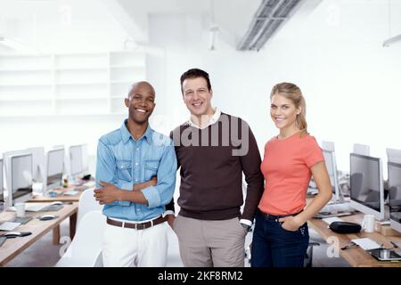 Their confident workers. Portrait of three business colleagues standing in the office. Stock Photo