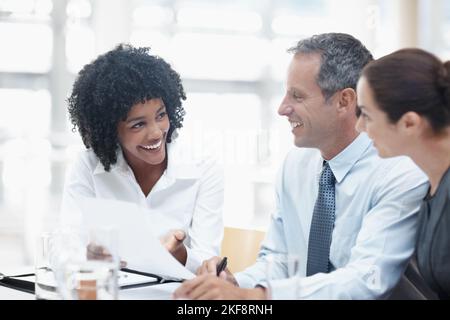 These figures are unbelievable. A diverse group of employees talking business during a meeting. Stock Photo