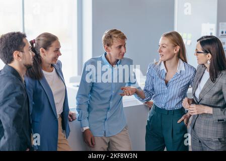 Employees chat informally and lively during the break. Stock Photo