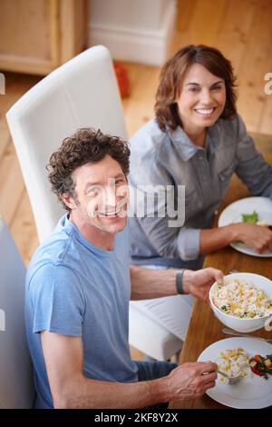 Meals are always better with the one you love. Portrait of a smiling couple having a meal together. Stock Photo