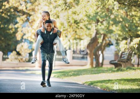 Fitness, piggyback and couple doing workout in nature together for health, wellness and exercise. Happy, energy and interracial man and woman doing Stock Photo
