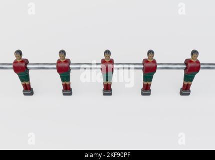 A single line of worn figurines from a vintage foosball or table football table styled in kit resembling the Portugal national team - 3D render Stock Photo